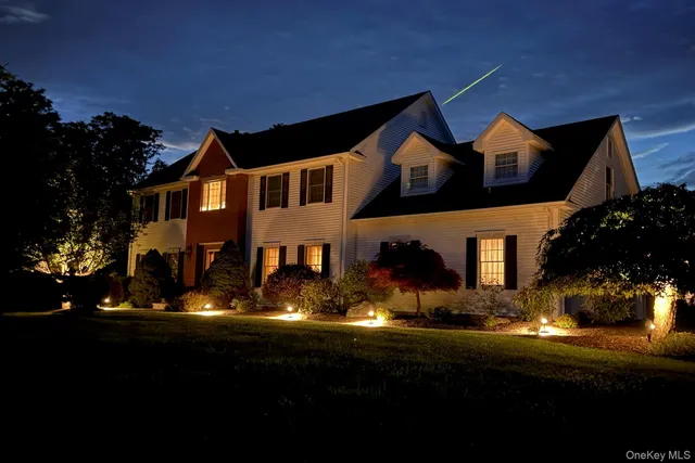 a front view of house with yard and green space