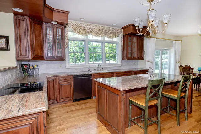 a kitchen with a stove a sink a dining table and chairs