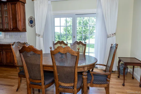 a dining room with furniture and window