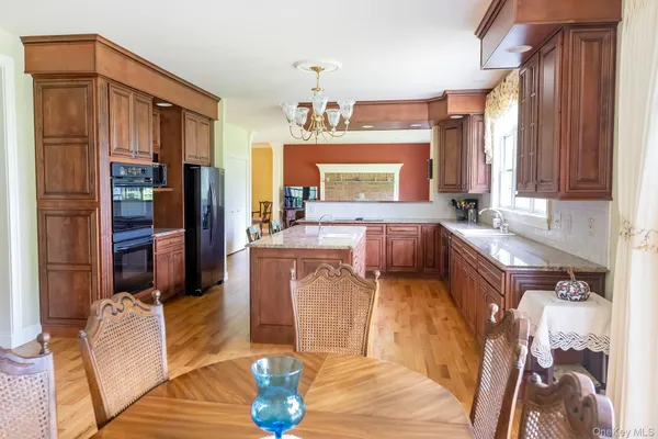 a living room with furniture a fireplace and a chandelier