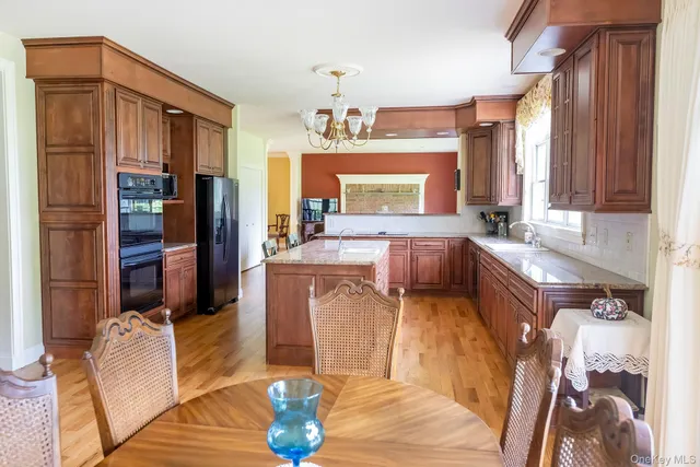 a living room with furniture a fireplace and a chandelier