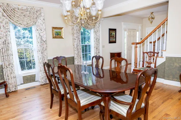 a view of a dining room with furniture window and wooden floor
