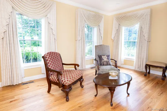 a view of a livingroom with furniture and a window