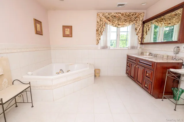 a bathroom with a bathtub sink and a window
