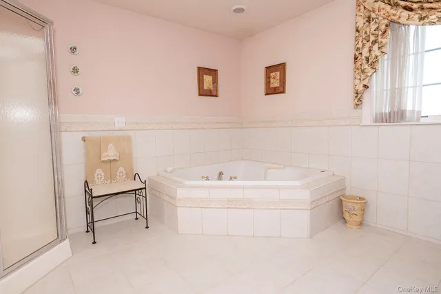 a bathroom with a sink a bathtub and window