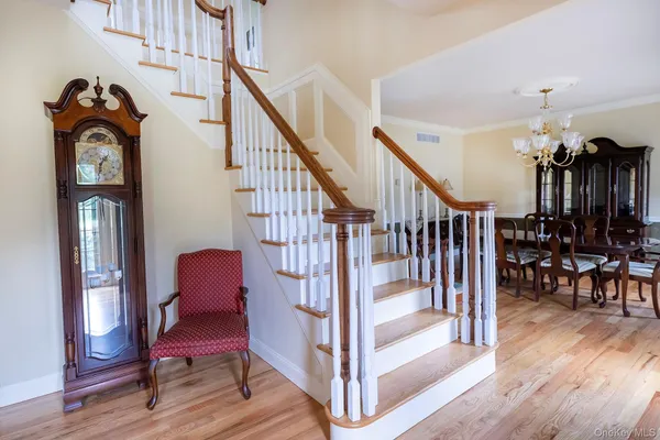a view of entryway livingroom and hall with wooden floor