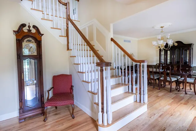 a view of entryway livingroom and hall with wooden floor