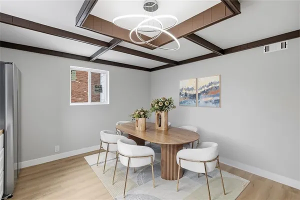 a dining room with furniture and wooden floor
