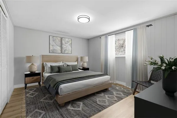 a bedroom with a bed and a potted plant