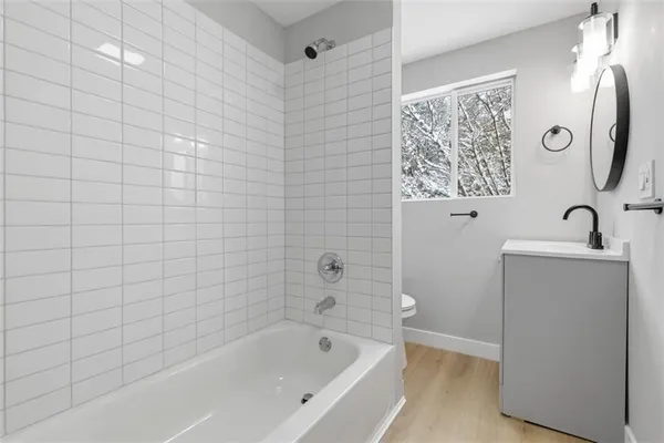 a bathroom with a bathtub and shower