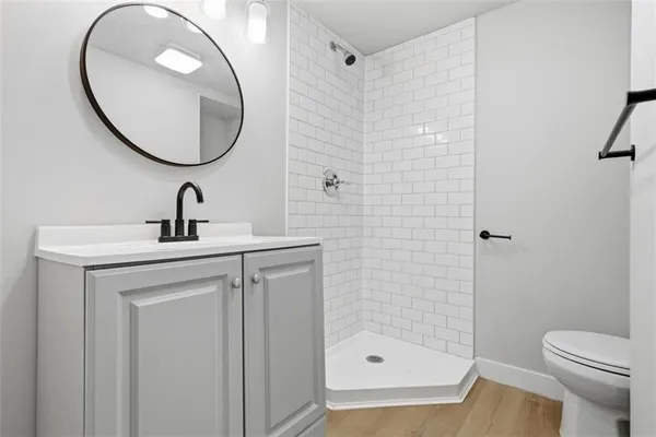 a bathroom with a sink a toilet and a mirror