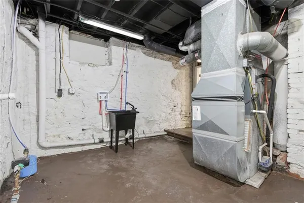 a view of water heater room with stairs