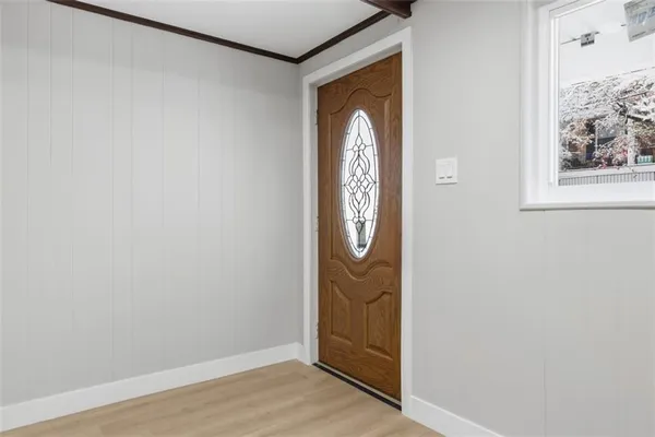 a view of front door with wooden floor