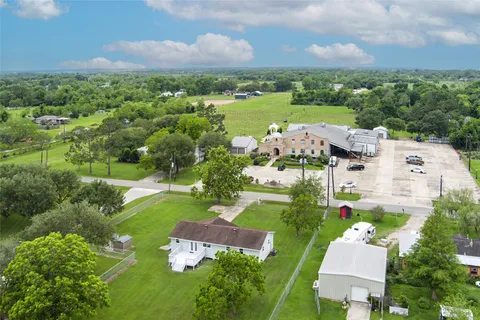 an aerial view of house with yard swimming pool and outdoor seating