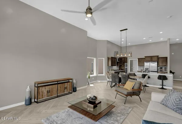 a living room with furniture and view of kitchen