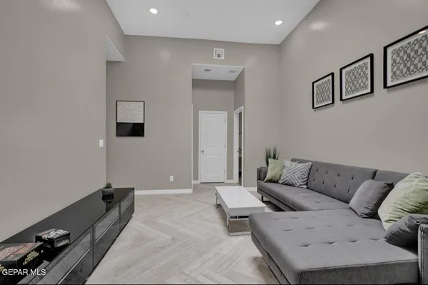 a living room with furniture and a potted plant