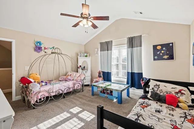 a bedroom with bed and a chandelier