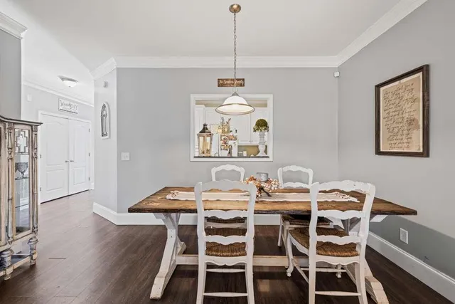 a view of a dining room with furniture wooden floor and a chandelier