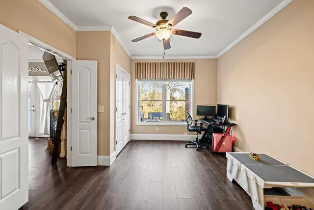 a view of a livingroom with workspace and a window