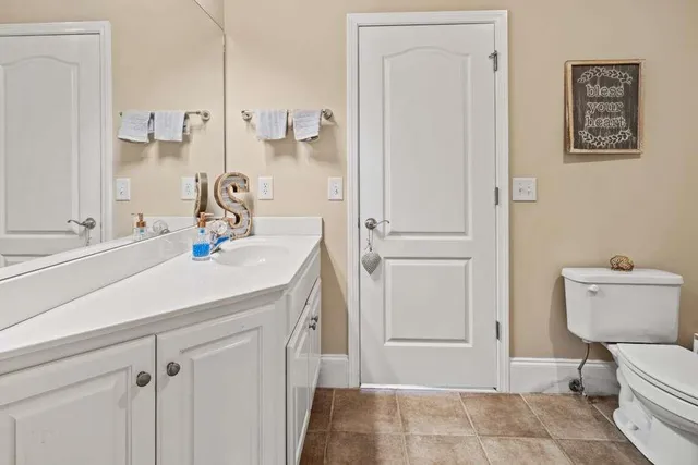 a bathroom with a sink a toilet and a mirror