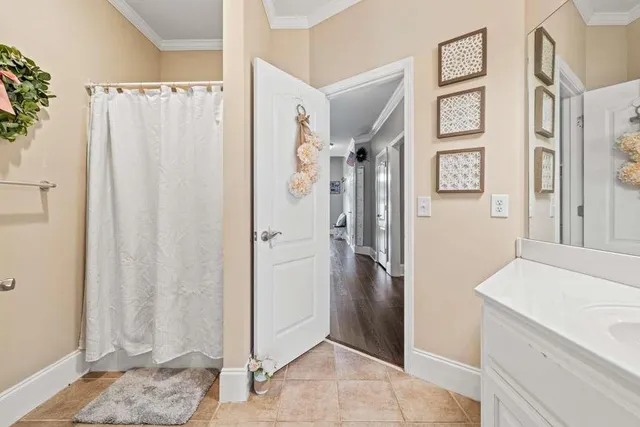 a view of bathroom with a shower and a sink