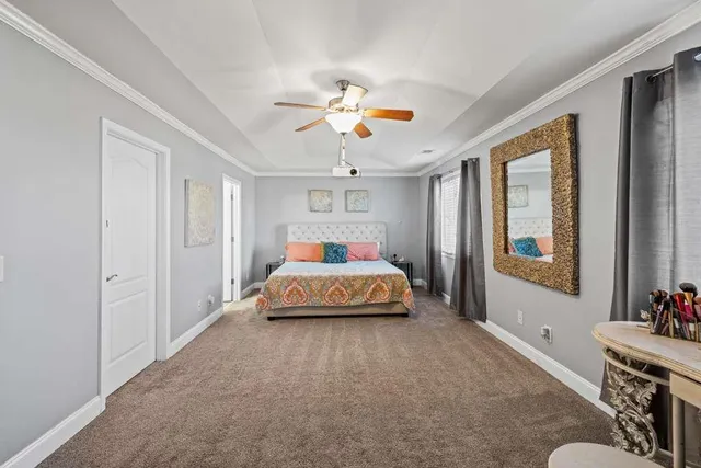 a bedroom with a bed and a chandelier