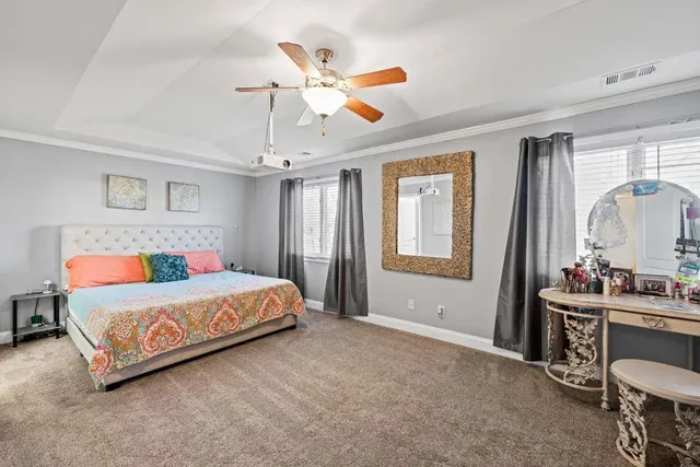 a bedroom with a bed a window and mirror