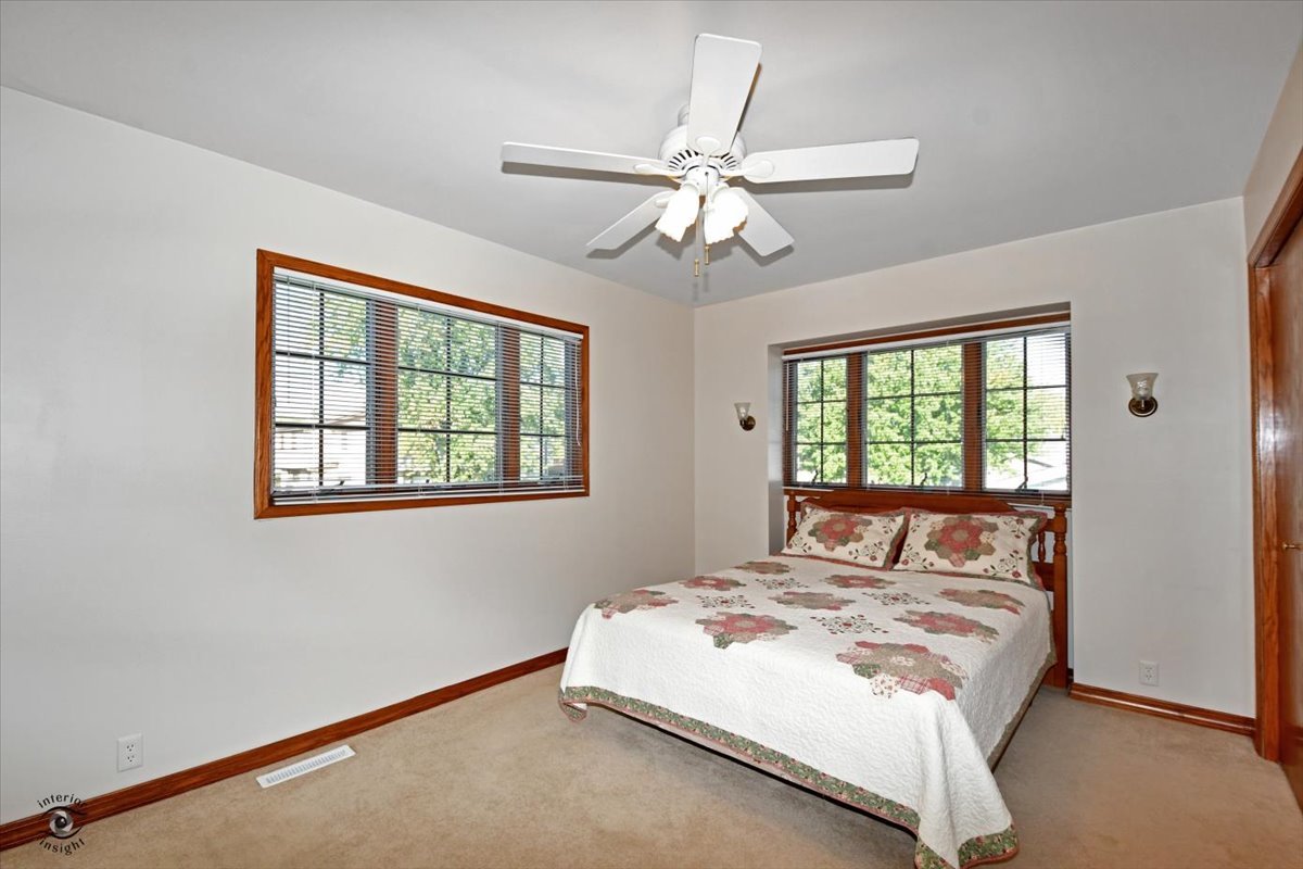 713 Southgate Road New Lenox, IL 60451 - Photo 11 of 25 a bedroom with a large bed and a window