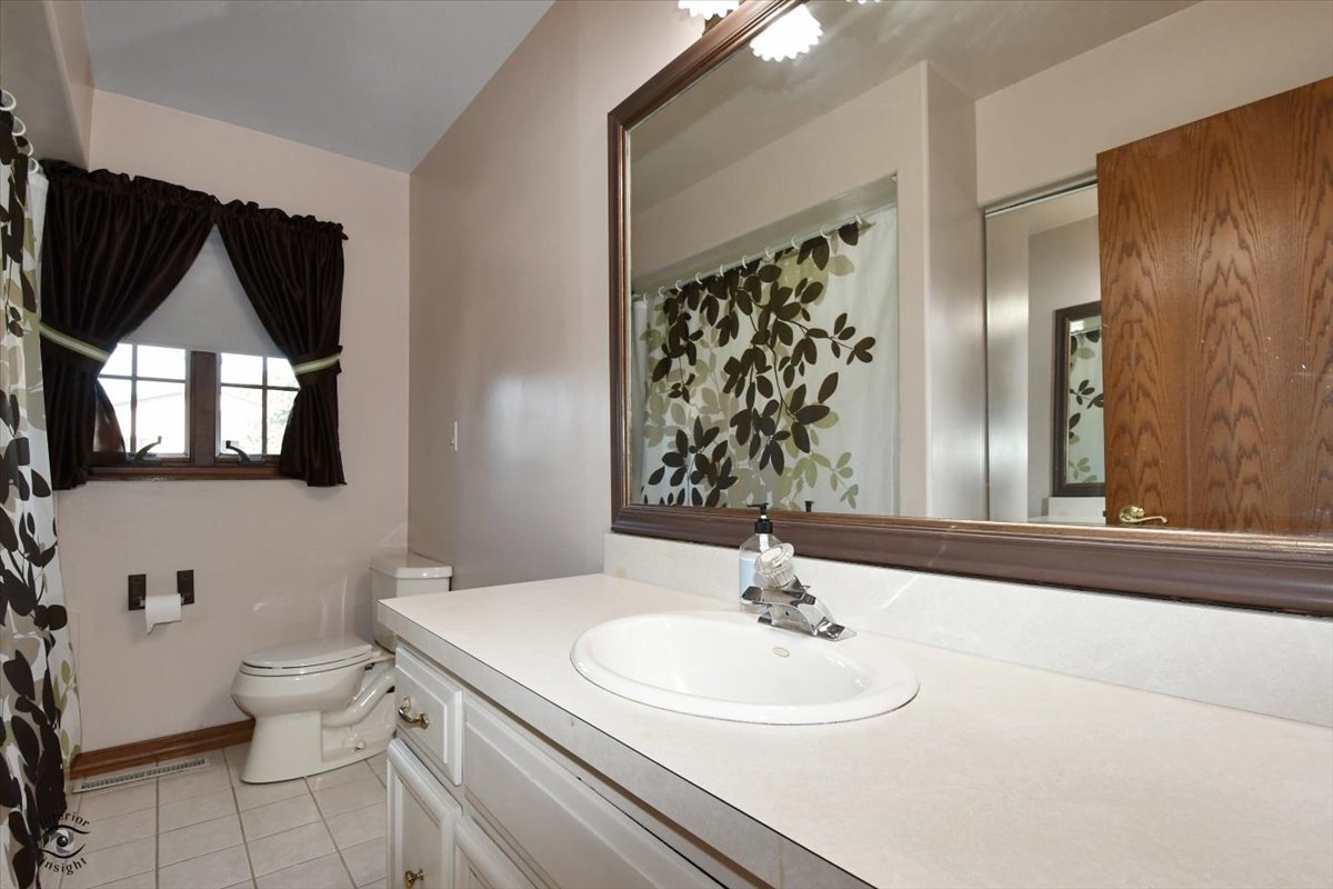 713 Southgate Road New Lenox, IL 60451 - Photo 12 of 25 a bathroom with a sink a toilet and mirror