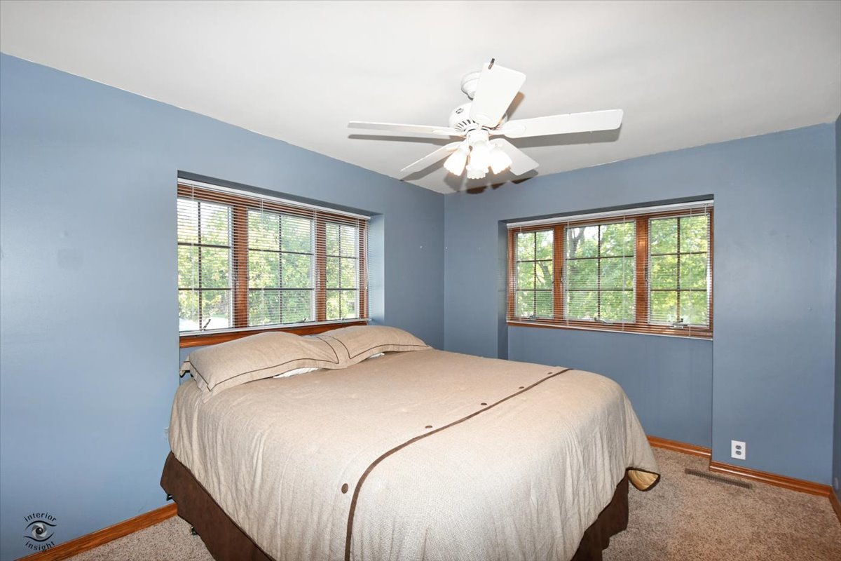 713 Southgate Road New Lenox, IL 60451 - Photo 13 of 25 a bedroom with a large bed and a window