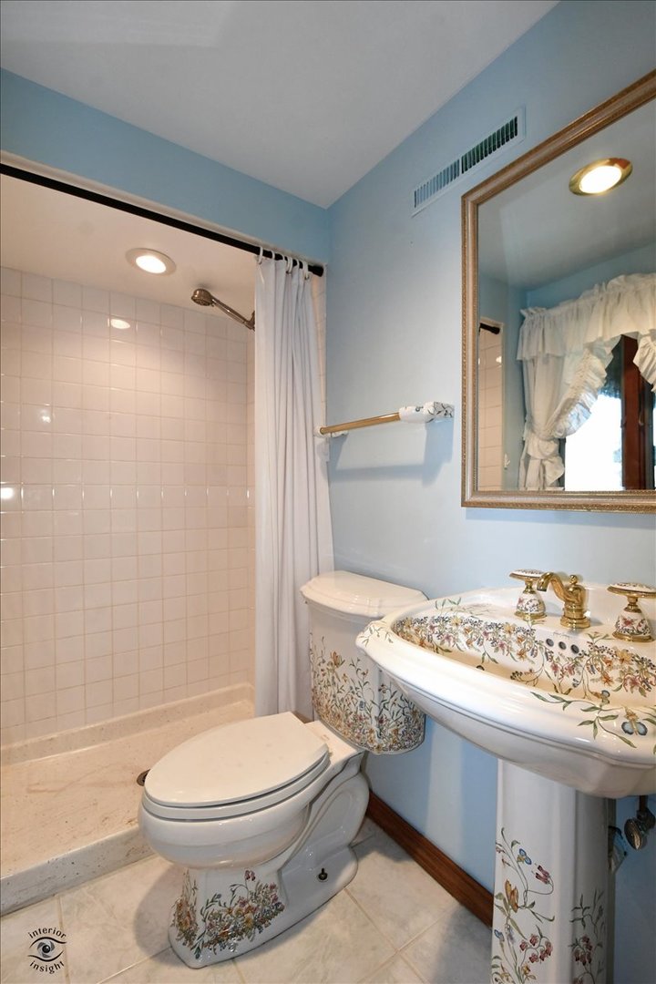 713 Southgate Road New Lenox, IL 60451 - Photo 19 of 25 a bathroom with a sink toilet and shower