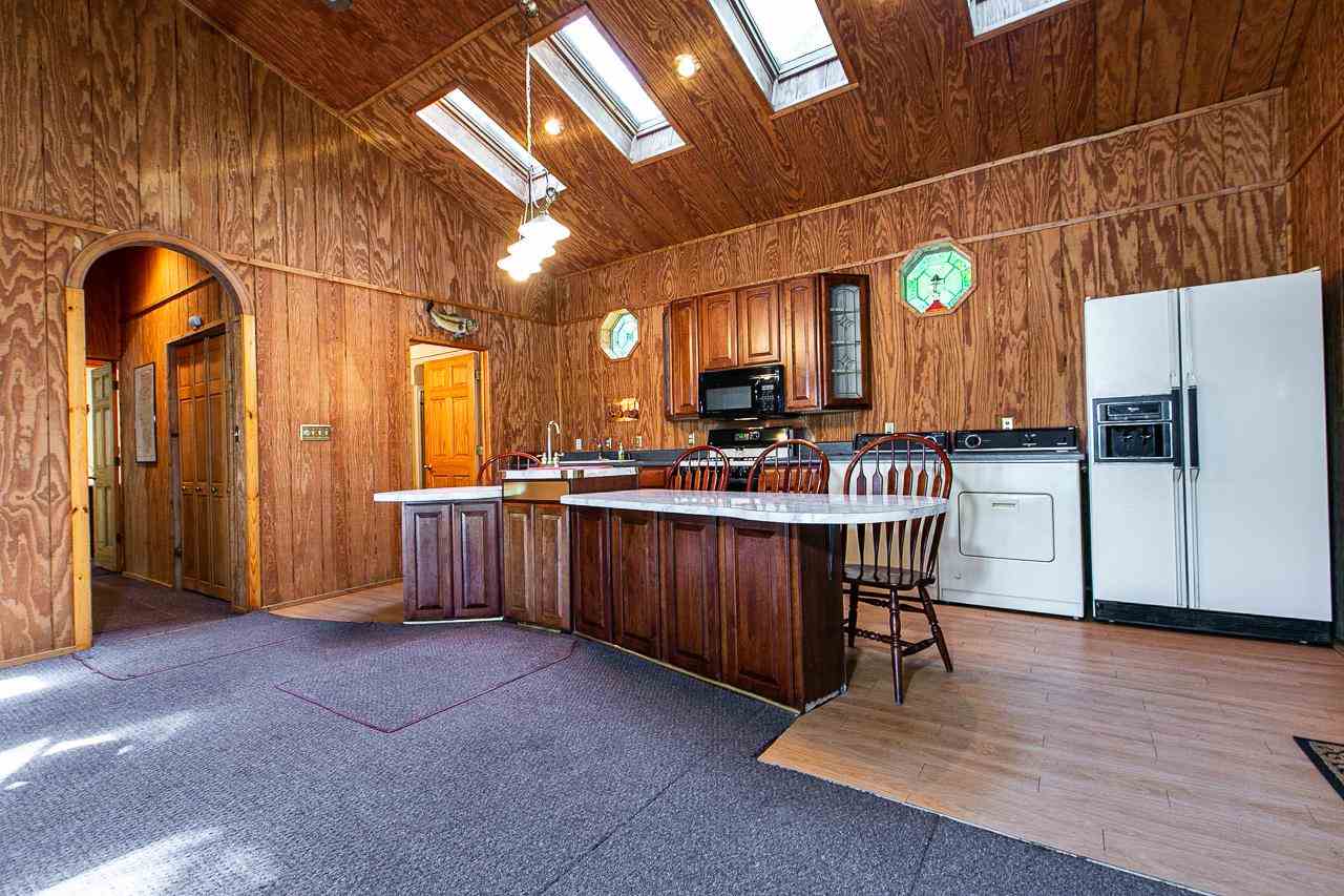 4804 South River Road Hanover, IL 61041 - Photo 10 of 31 a kitchen with a refrigerator and table