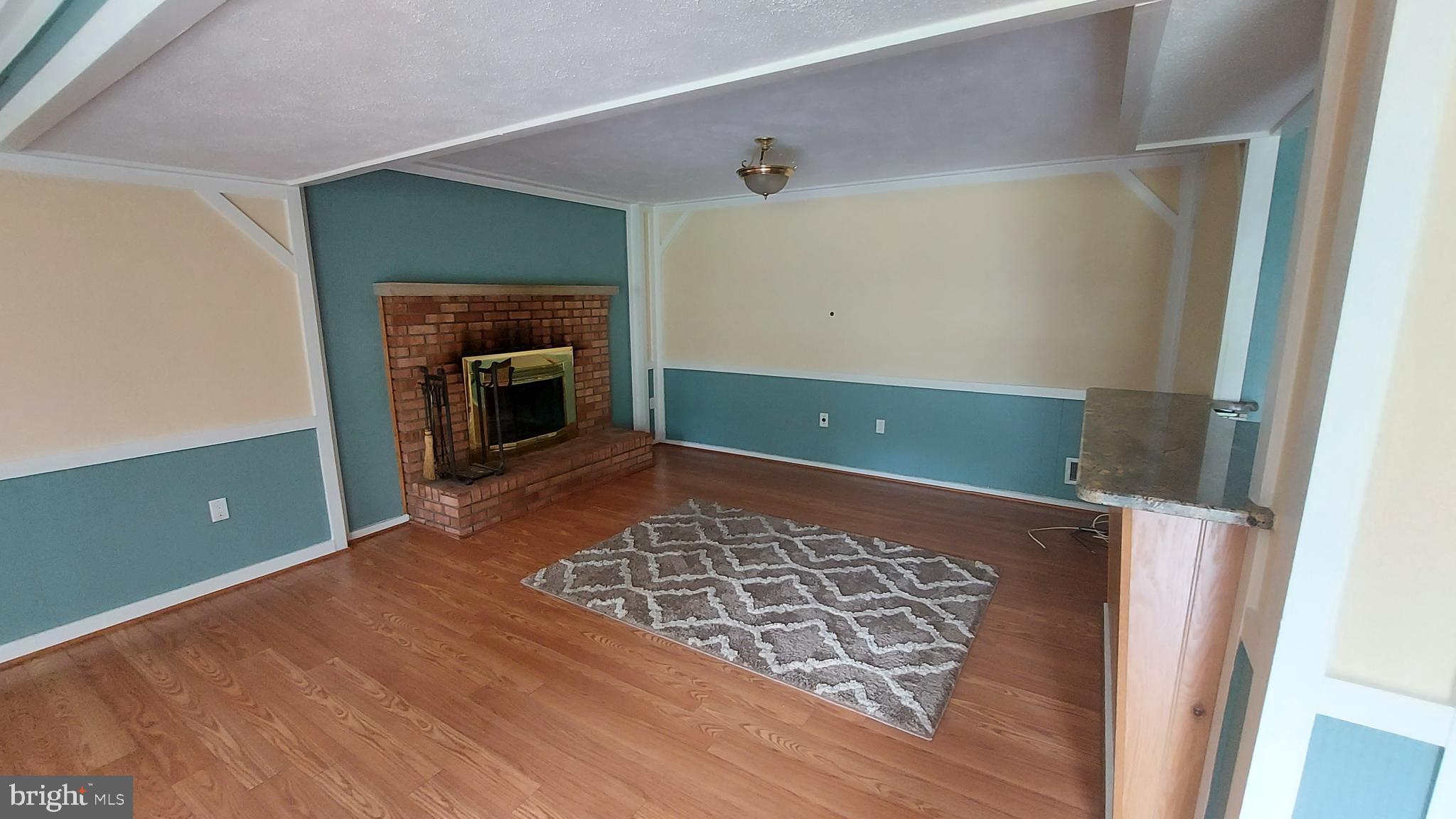 37730 Apache Road Charlotte Hall, MD 20622 - Photo 16 of 21 a view of an empty room with a fireplace and a window