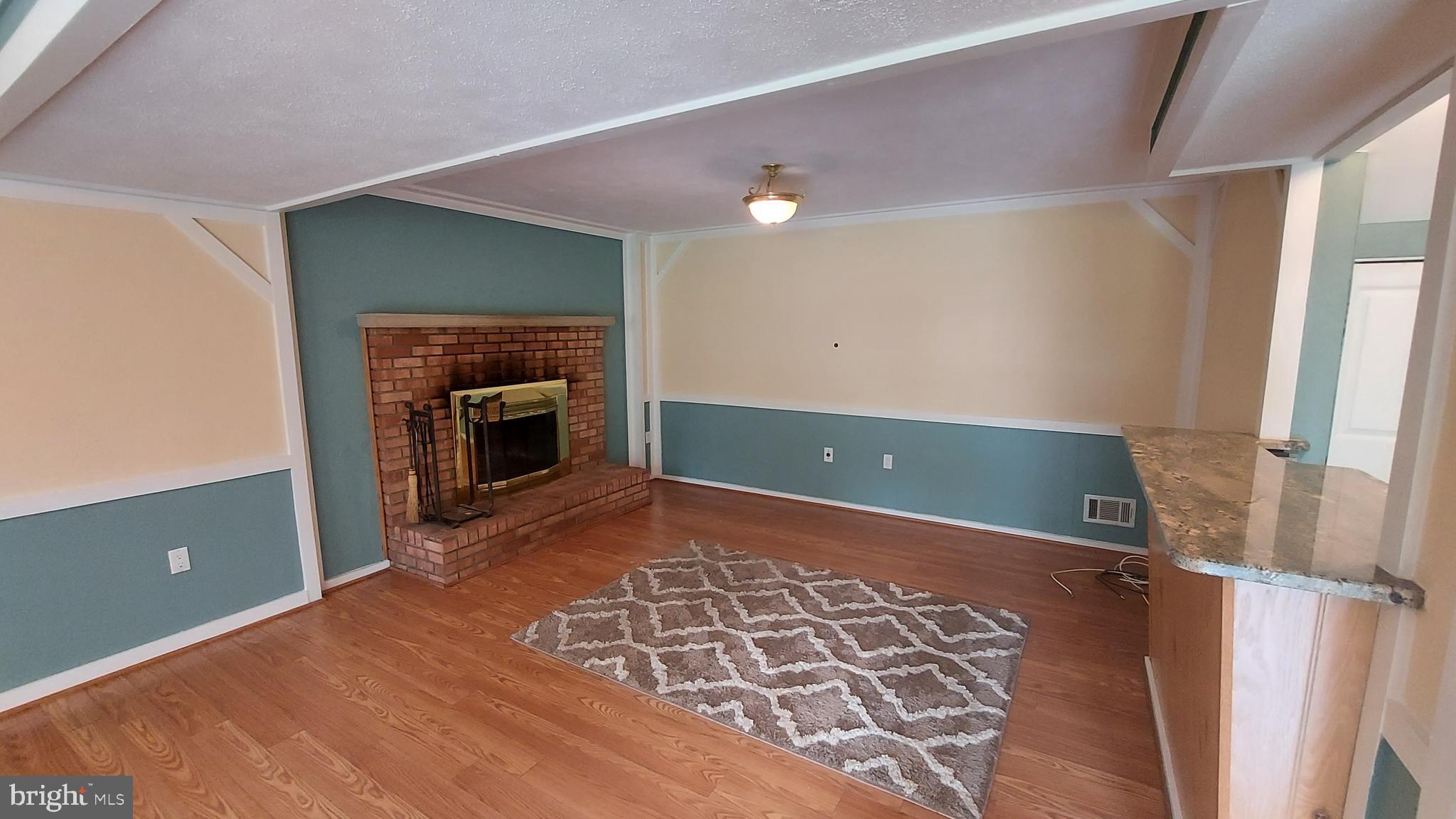 37730 Apache Road Charlotte Hall, MD 20622 - Photo 17 of 21 a view of a livingroom with a fireplace and a ceiling fan