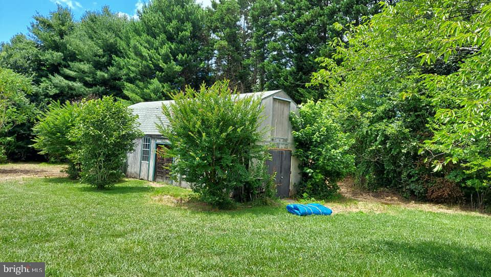 37730 Apache Road Charlotte Hall, MD 20622 - Photo 4 of 21 a garden with trees in front of it