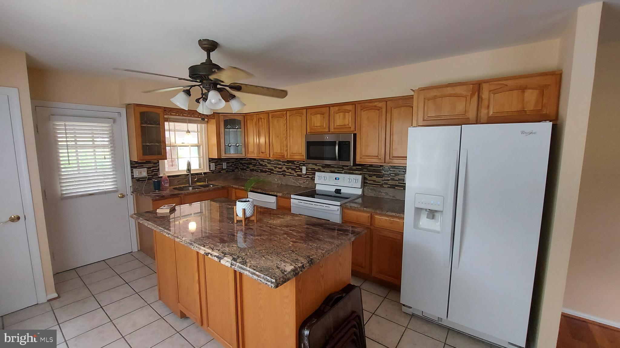 37730 Apache Road Charlotte Hall, MD 20622 - Photo 7 of 21 a kitchen with stainless steel appliances granite countertop a refrigerator a stove a sink and a microwave