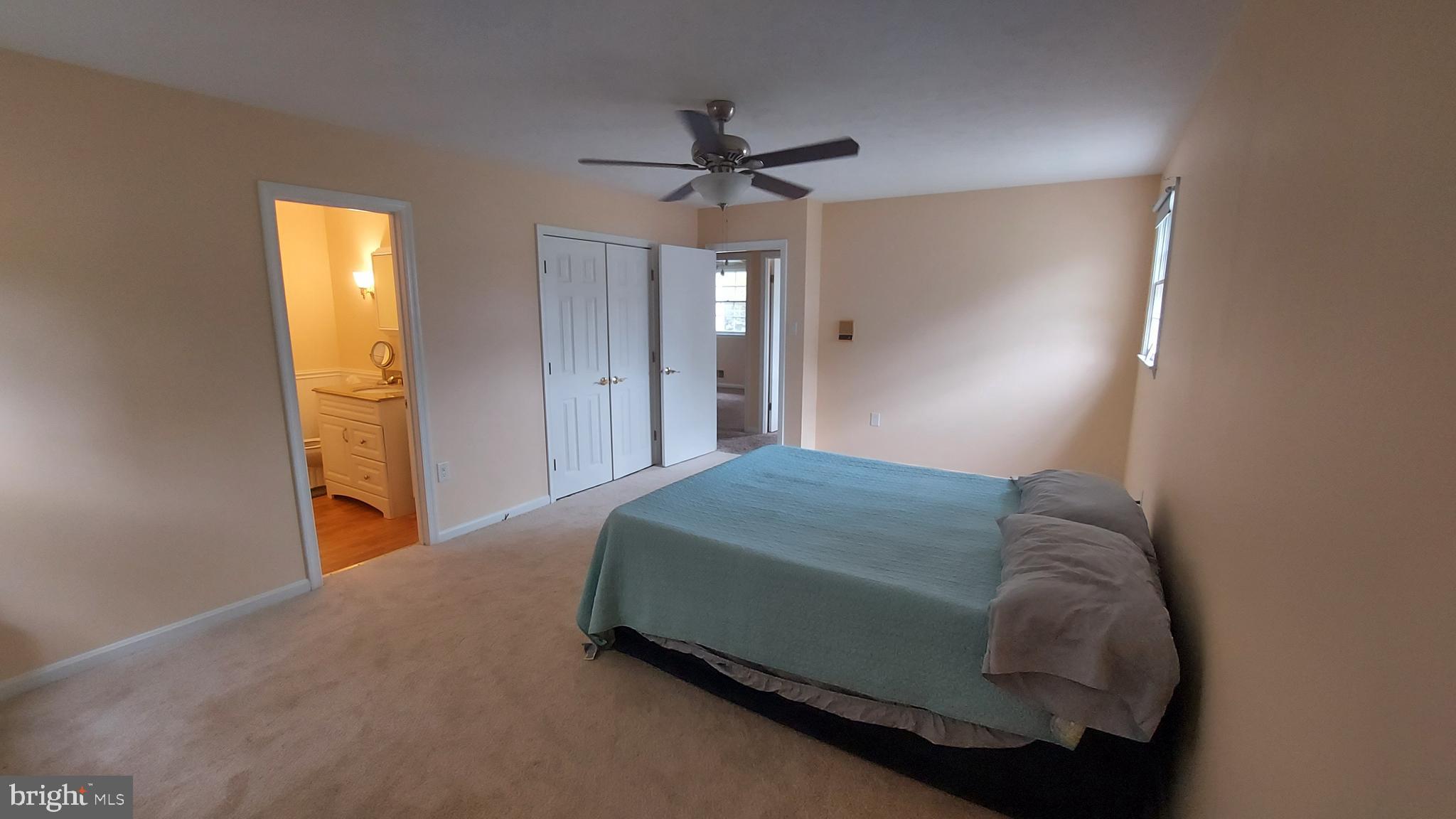 37730 Apache Road Charlotte Hall, MD 20622 - Photo 10 of 21 a bedroom with a bed and a chandelier