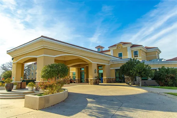 a view of a building with couches and table