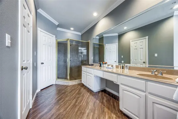 a large white bathroom with a double vanity sink and mirror