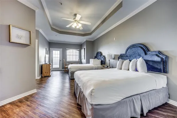 a bedroom with bed and wooden floor