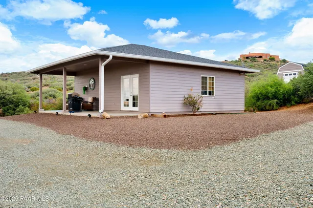 an aerial view of residential houses with outdoor space and trees