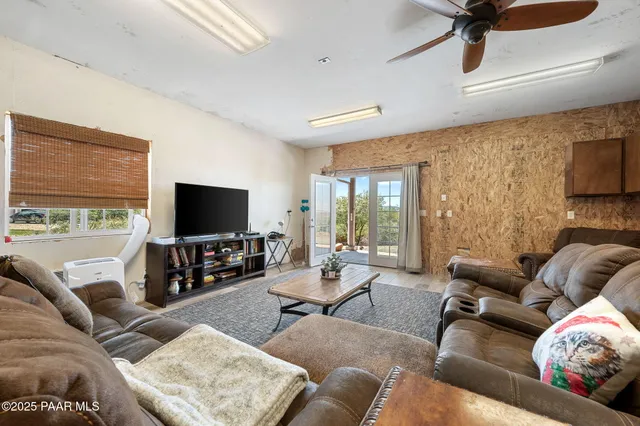 a view of a house with backyard and sitting area