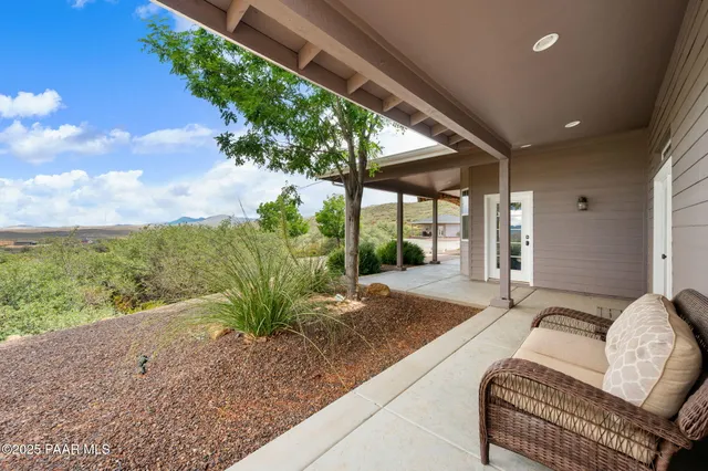 a view of a livingroom with furniture a dinning room and windows
