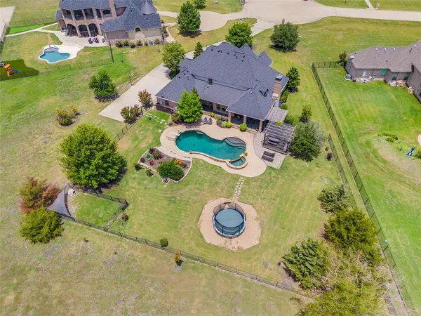 an aerial view of residential house with yard