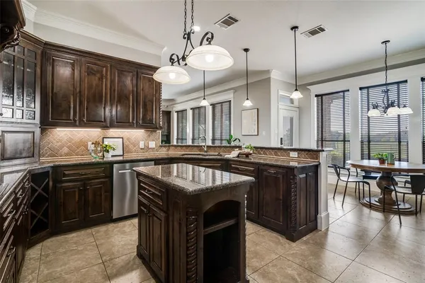 a kitchen with a stove kitchen island and couches with wooden floor