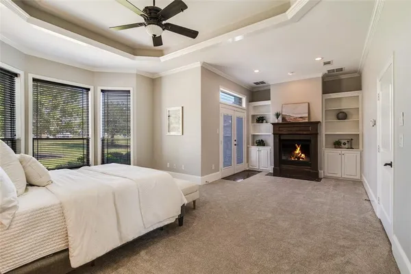 a large bedroom with a bed and a fireplace