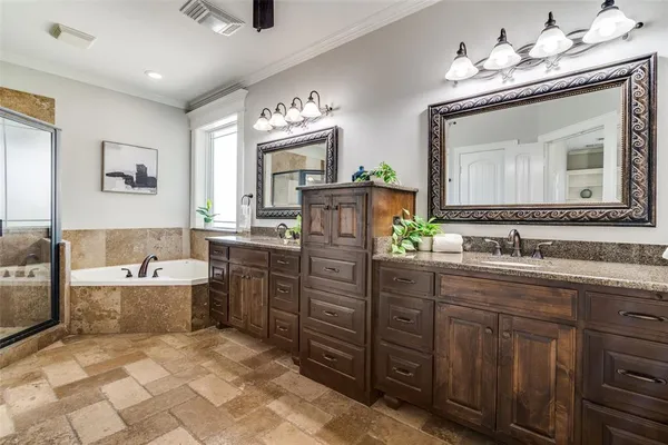 a bathroom with a granite countertop sink a large mirror and a bathtub