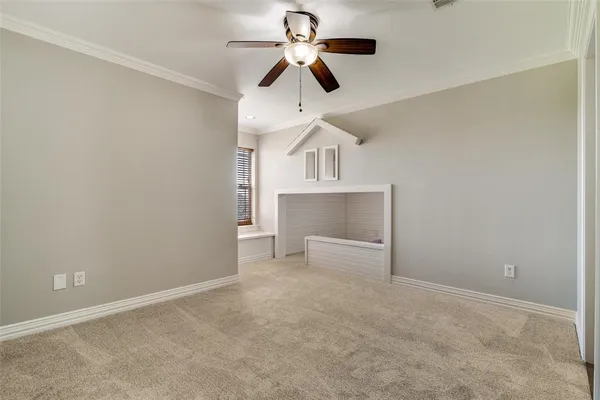 a view of empty room with ceiling fan
