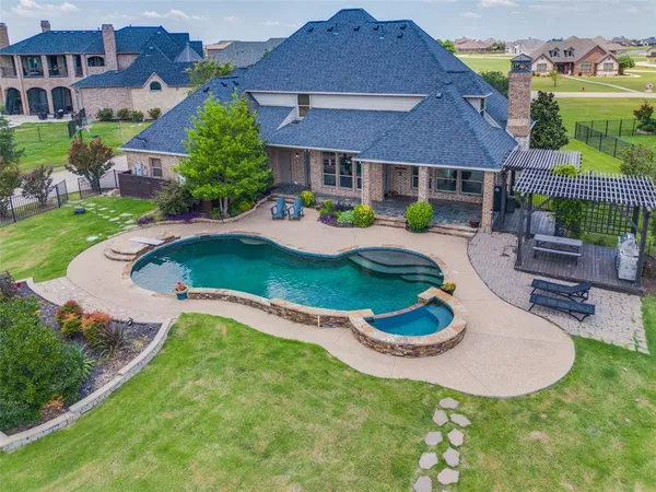 a swimming pool with outdoor seating yard and barbeque oven