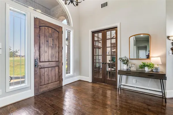 a view of an entryway with wooden floor